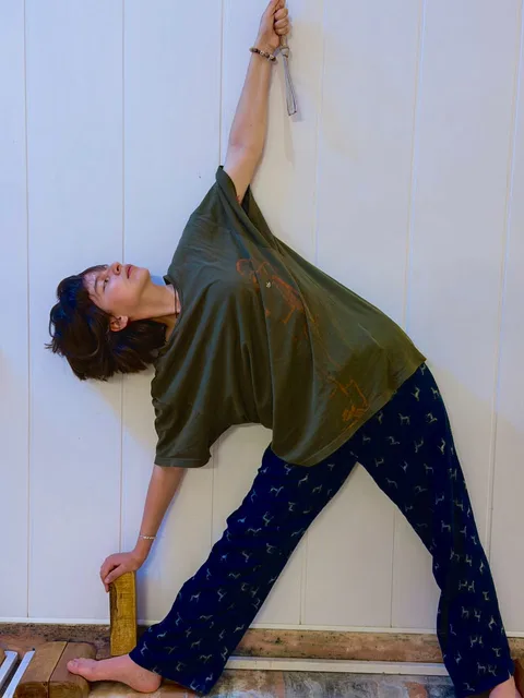 A student practising a standing side stretch