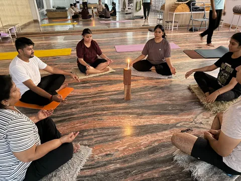 Students sitting together on yoga mats at Yogshala