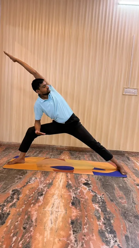 A standing side stretch during yoga practice at Yogshala