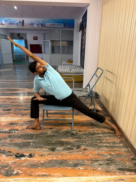 A supported standing side stretch using a chair