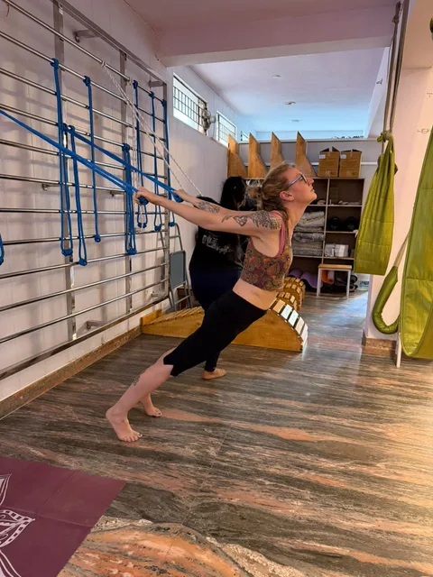 Yoga practice using wall ropes in the studio
